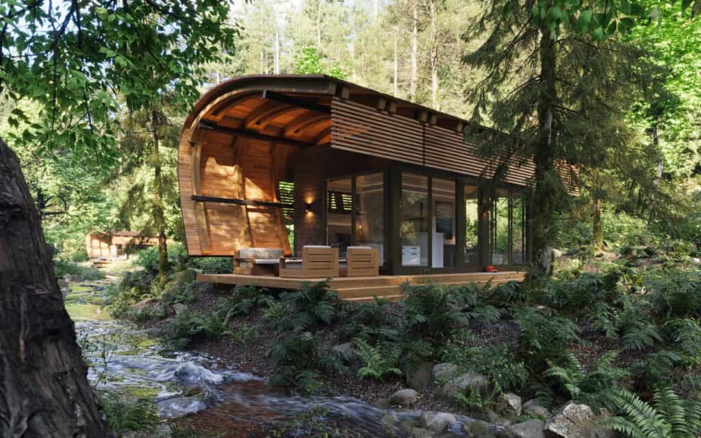 Posh-outdoors-wooden-cabin-in-forest-with-stream-seating-area.